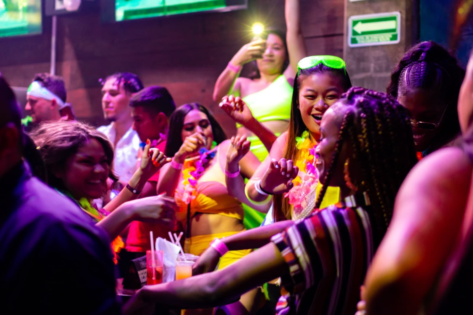 Crowd dancing with neon leis on a Best Clubs in Cabo open-bar club night in Cabo San Lucas